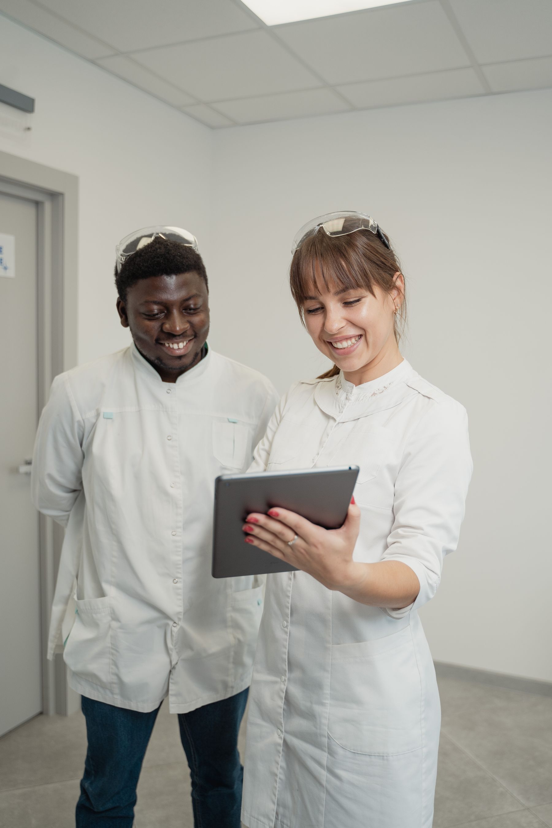 Two healthcare professionals reviewing a tablet.